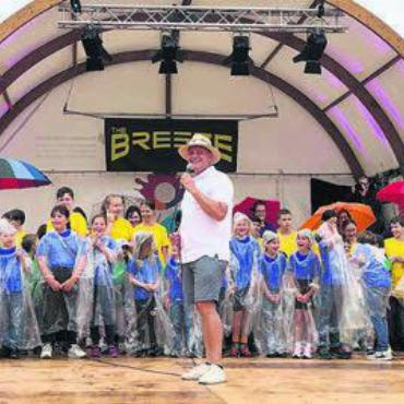 Lebendiger Regenbogen - Mit einem breiten Strahlen trotzen die Kinder zusammen mit OK-Präsident Matthias Oldani dem Regen an der Eröffnungsfeier.